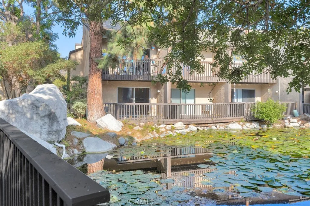 7890 East Spring Street, Unit 4A Long Beach, CA 90815 - Photo 2 of 21 a front view of a house with swimming pool