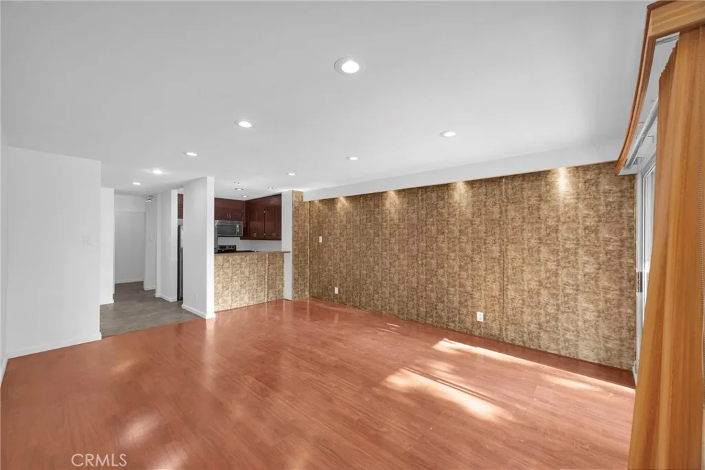 7890 East Spring Street, Unit 4A Long Beach, CA 90815 - Photo 5 of 21 a view of a big room with wooden floor and windows