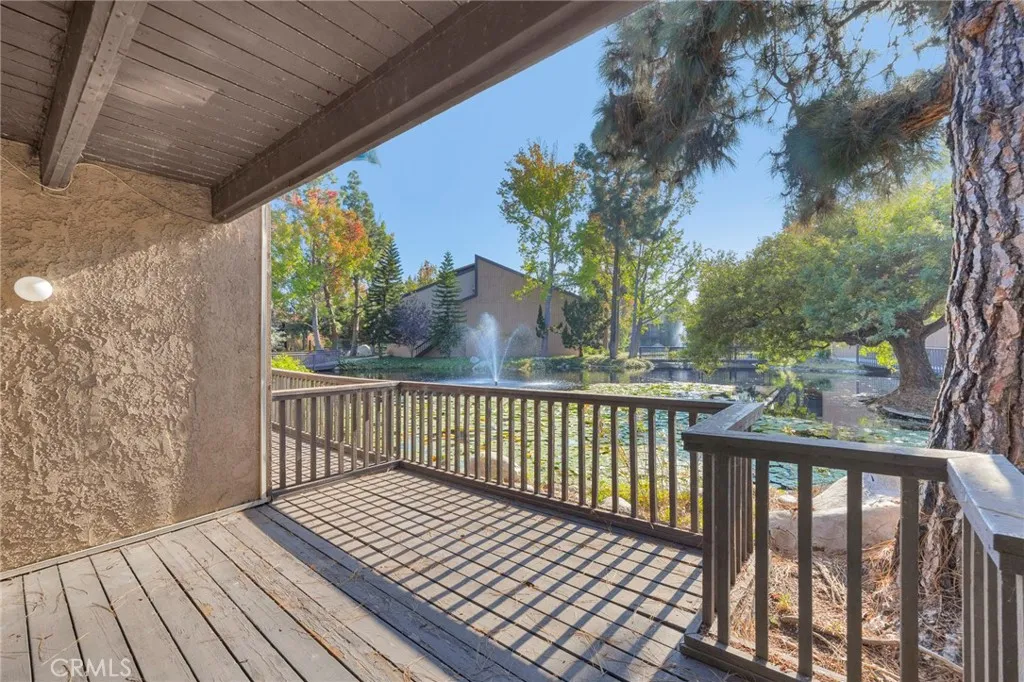 7890 East Spring Street, Unit 4A Long Beach, CA 90815 - Photo 10 of 21 a view of balcony with wooden floor and fence