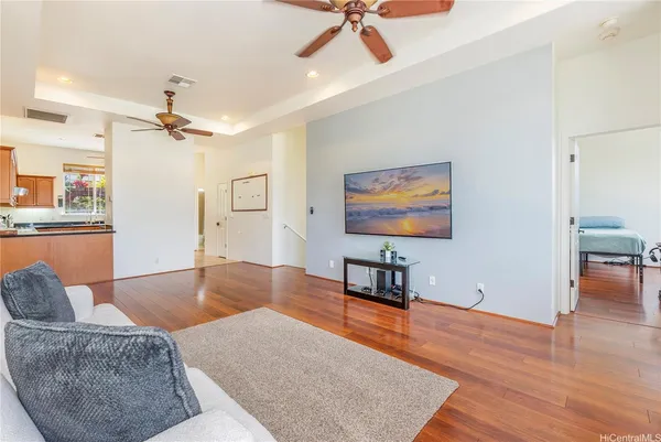a living room with furniture and a ceiling fan