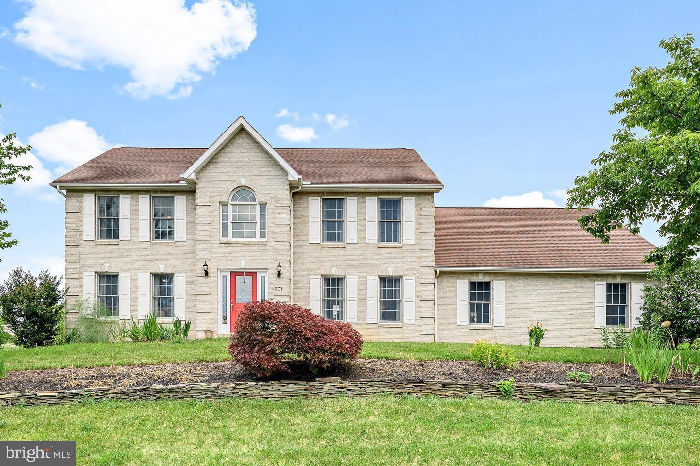 201 Sunbrook Drive Chambersburg, PA 17201 - Photo 1 of 42 a front view of a house with a garden and plants