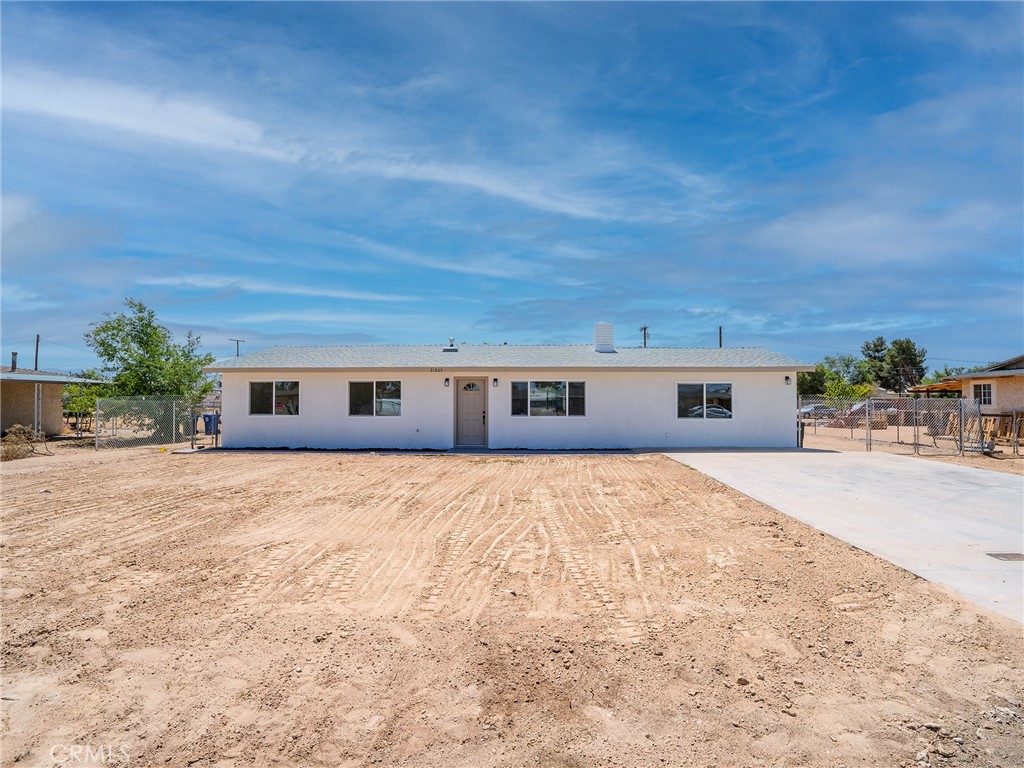 21865 Fox Apple Valley, CA 92307 - Photo 1 of 27 a front view of house with yard and trees in the background