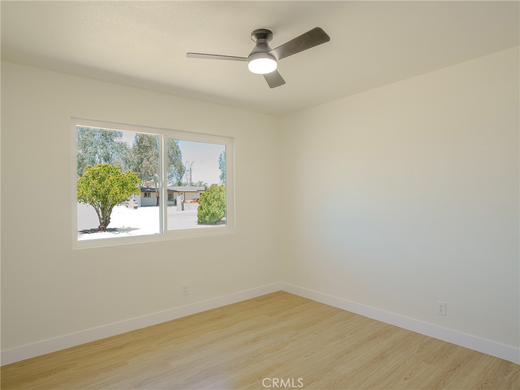 21865 Fox Apple Valley, CA 92307 - Photo 13 of 27 an empty room with a window and a ceiling fan