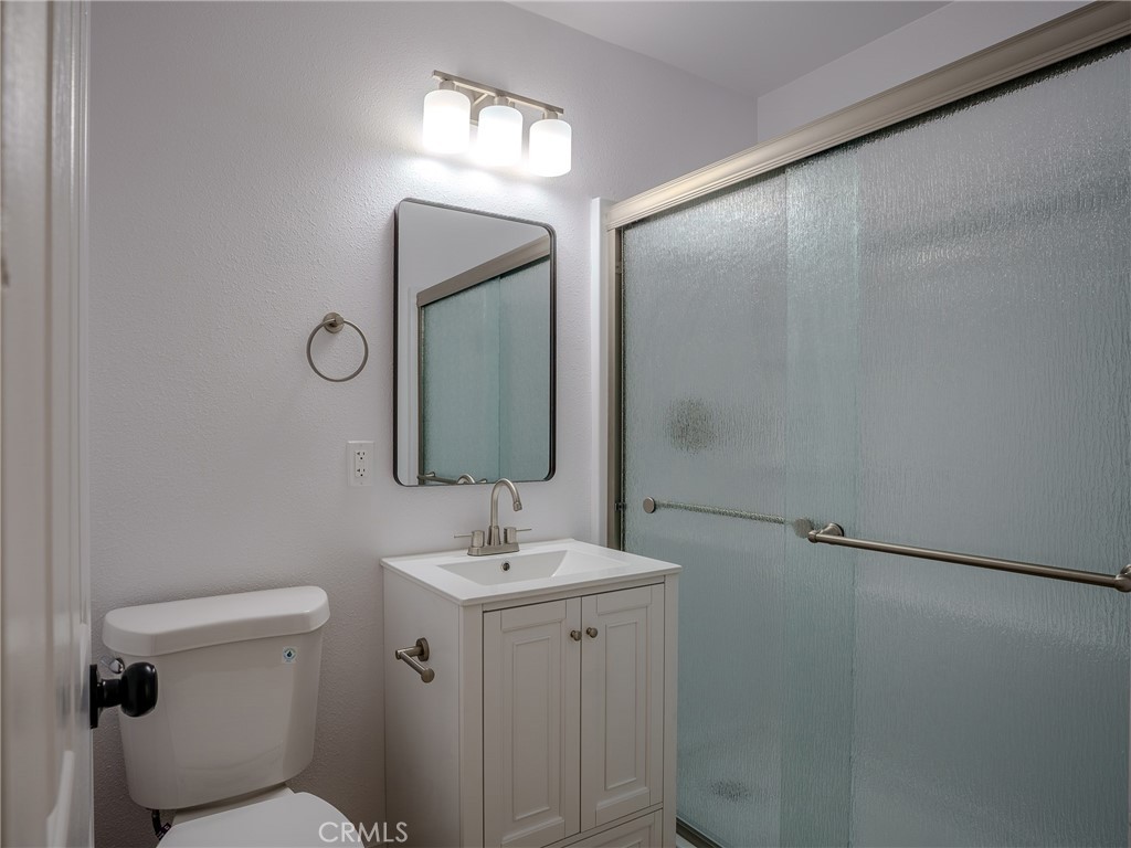 21865 Fox Apple Valley, CA 92307 - Photo 14 of 27 a bathroom with a toilet sink and mirror