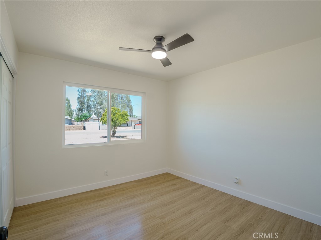21865 Fox Apple Valley, CA 92307 - Photo 15 of 27 an empty room with wooden floor and windows