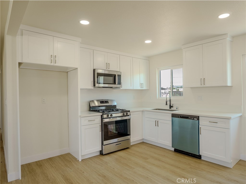 21865 Fox Apple Valley, CA 92307 - Photo 4 of 27 a kitchen with stainless steel appliances granite countertop a stove a sink and a microwave