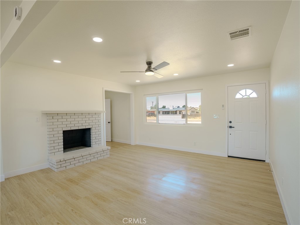 21865 Fox Apple Valley, CA 92307 - Photo 6 of 27 an empty room with windows and fireplace
