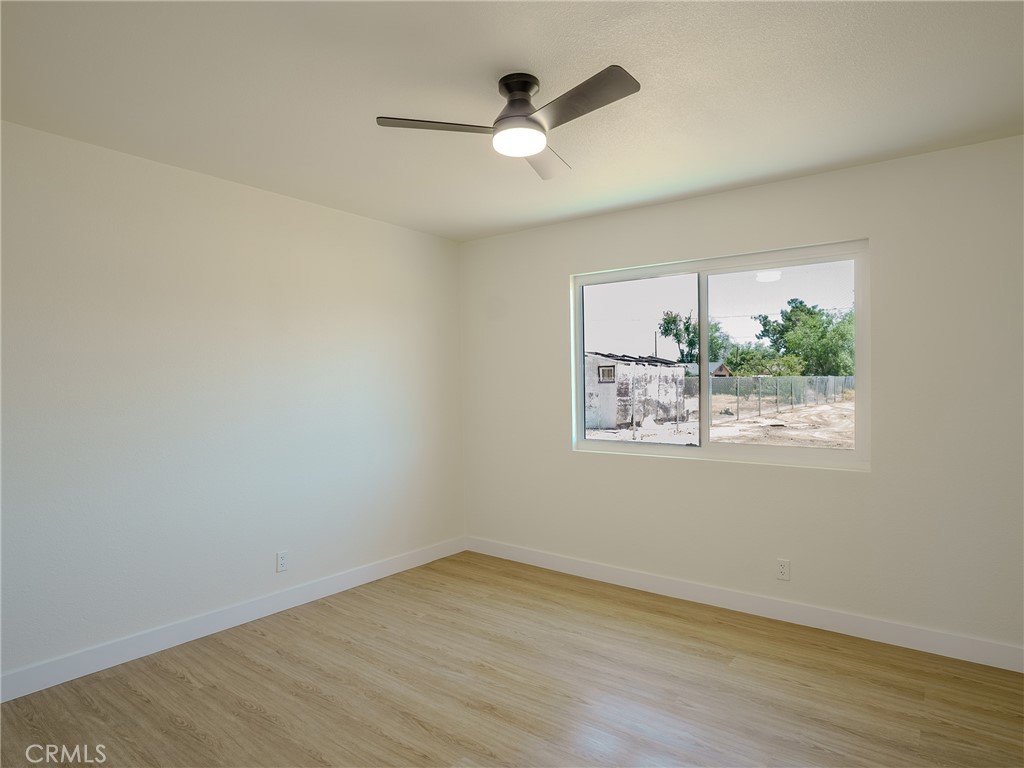 21865 Fox Apple Valley, CA 92307 - Photo 9 of 27 an empty room with wooden floor and windows