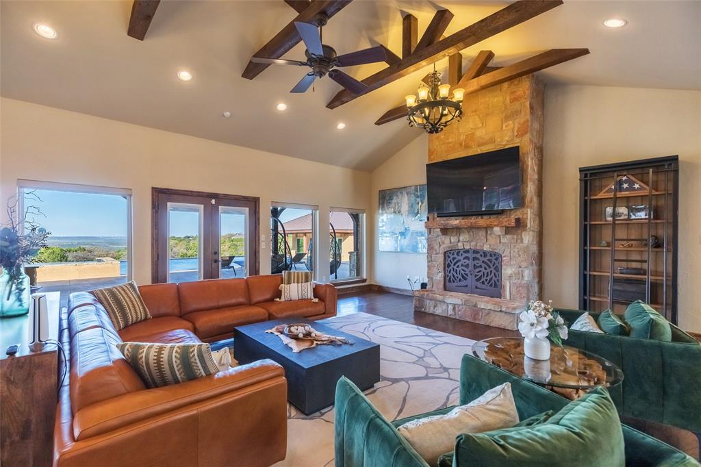 126 Phoenix Lane Tuscola, TX 79562 - Photo 14 of 40 a living room with furniture a ceiling fan and a fireplace