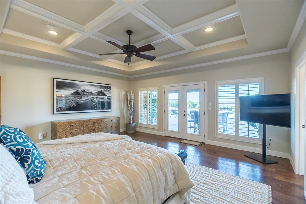 126 Phoenix Lane Tuscola, TX 79562 - Photo 23 of 40 a bedroom with a large bed and a chandelier