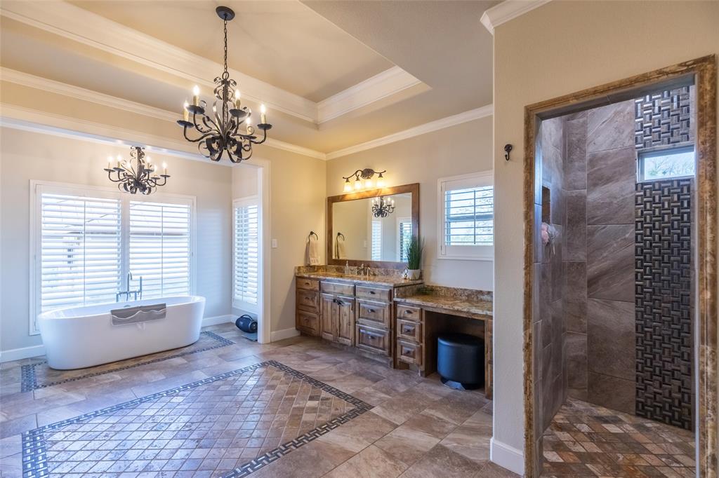 126 Phoenix Lane Tuscola, TX 79562 - Photo 27 of 40 a spacious bathroom with a granite countertop sink a toilet and shower