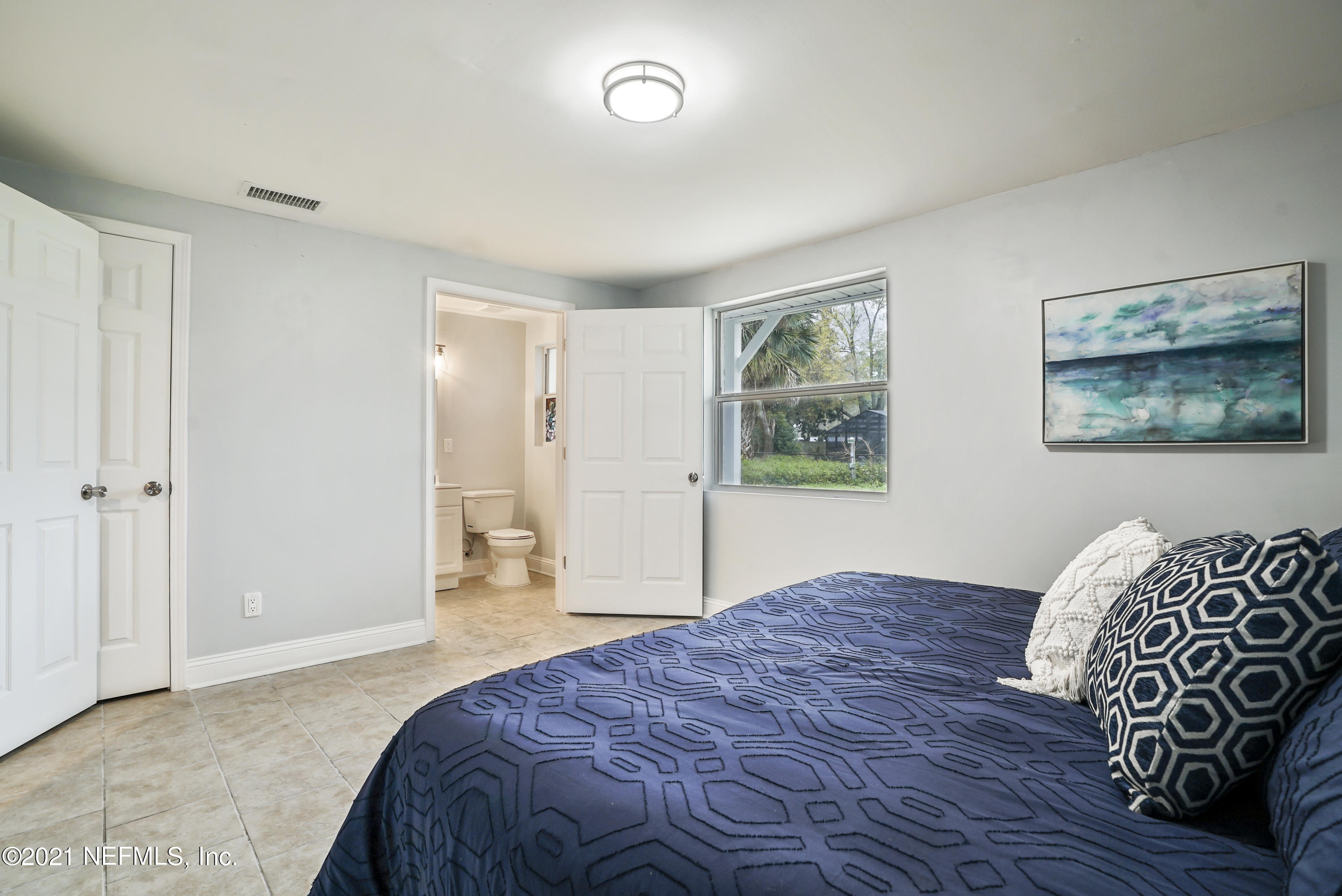 4175 Spring Glen Road Jacksonville, FL 32207 - Photo 11 of 25 a bedroom with a bed and a painting on the wall