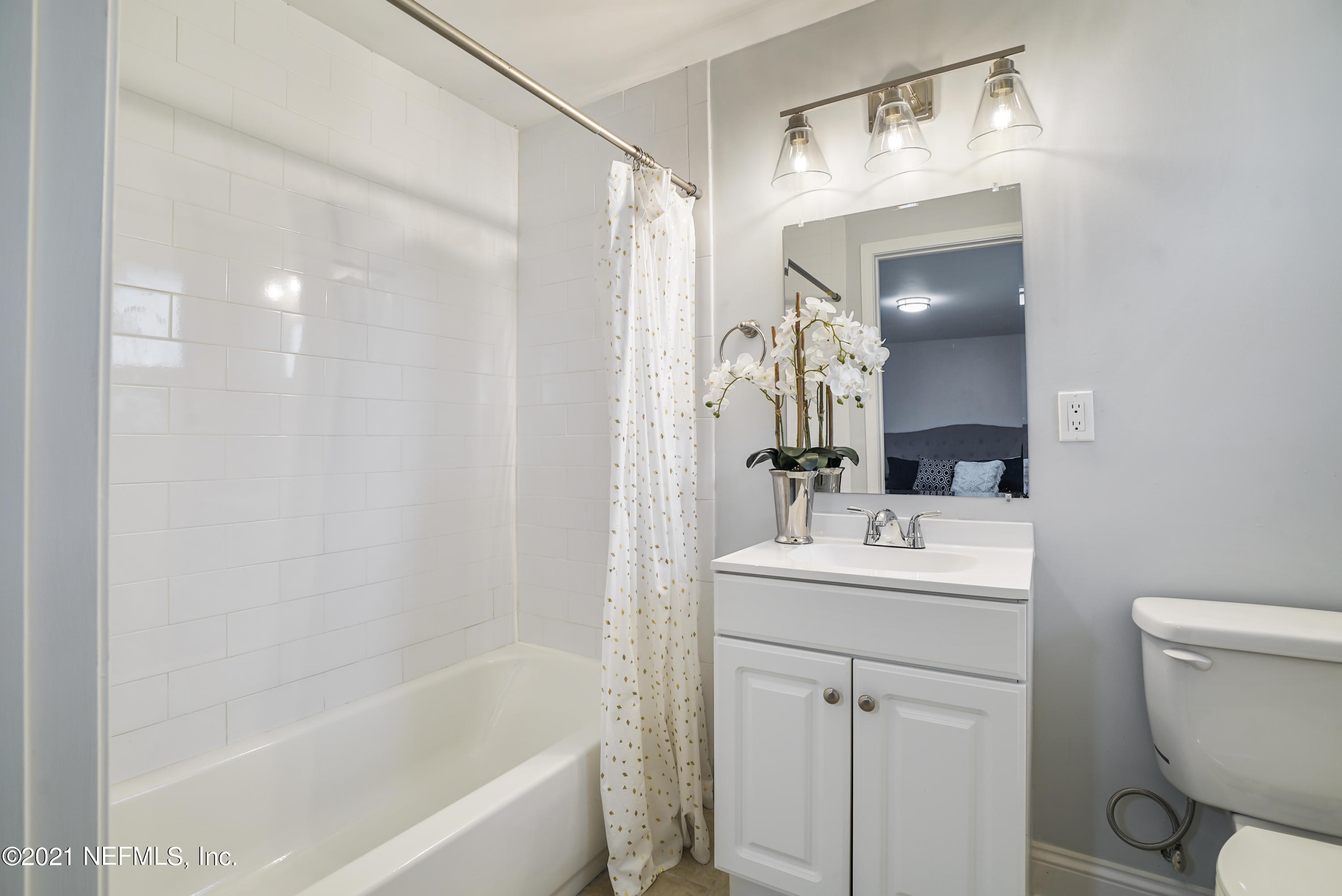 4175 Spring Glen Road Jacksonville, FL 32207 - Photo 12 of 25 a bathroom with a sink a toilet and shower a mirror