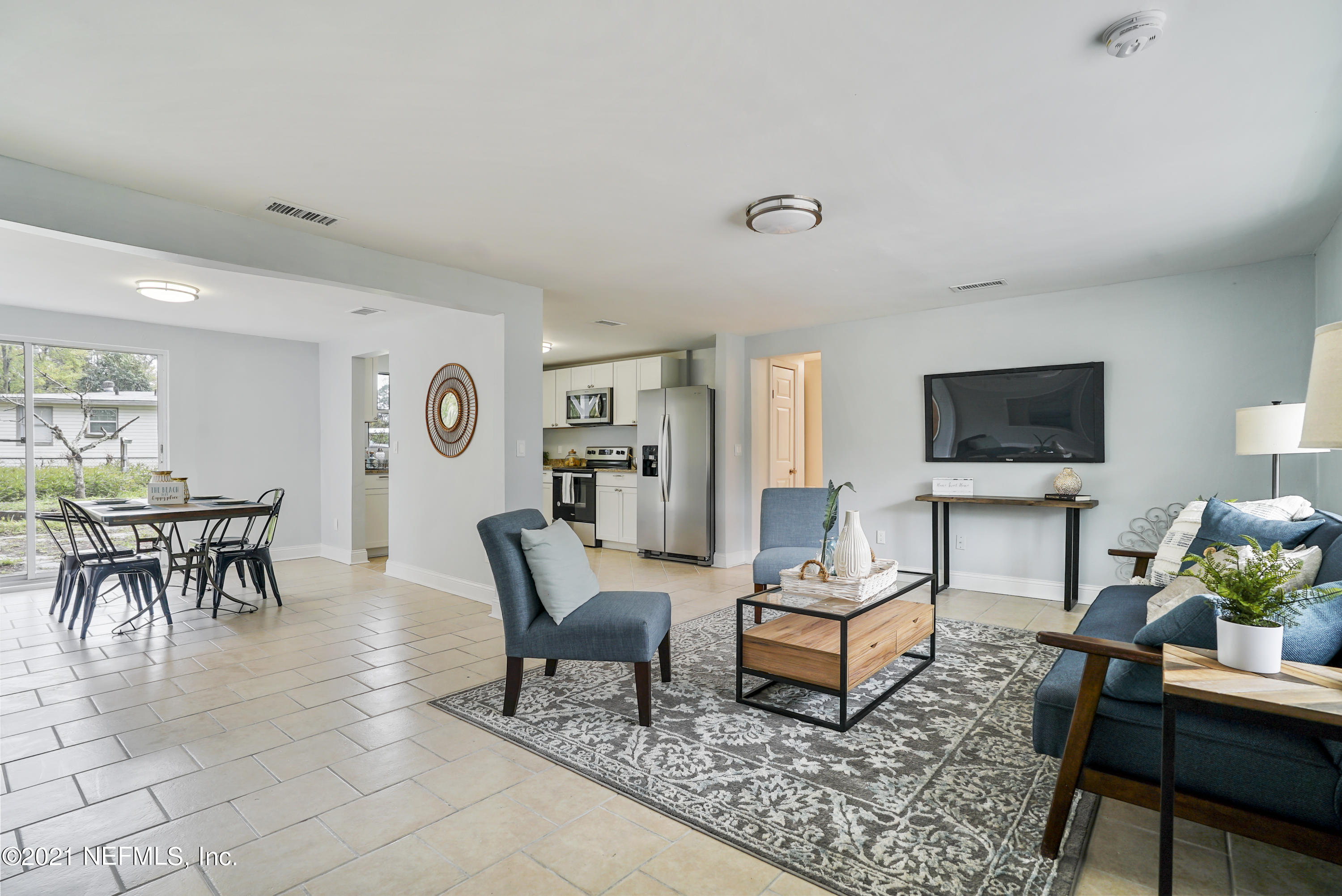 4175 Spring Glen Road Jacksonville, FL 32207 - Photo 3 of 25 a living room with furniture and a flat screen tv