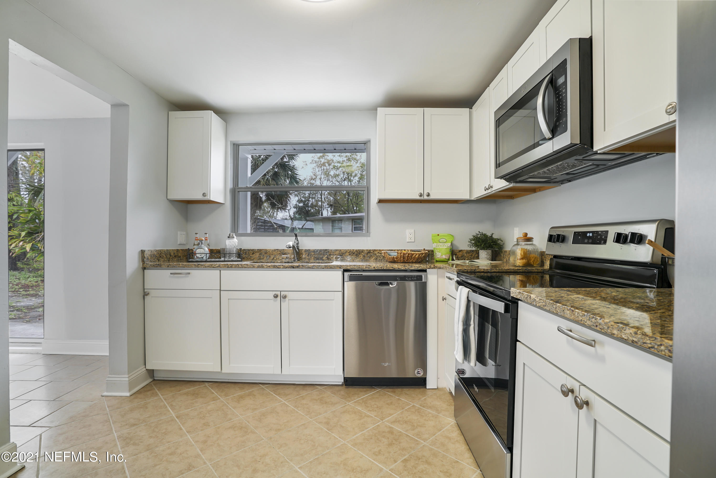 4175 Spring Glen Road Jacksonville, FL 32207 - Photo 8 of 25 a kitchen with stainless steel appliances granite countertop a sink and a stove top oven