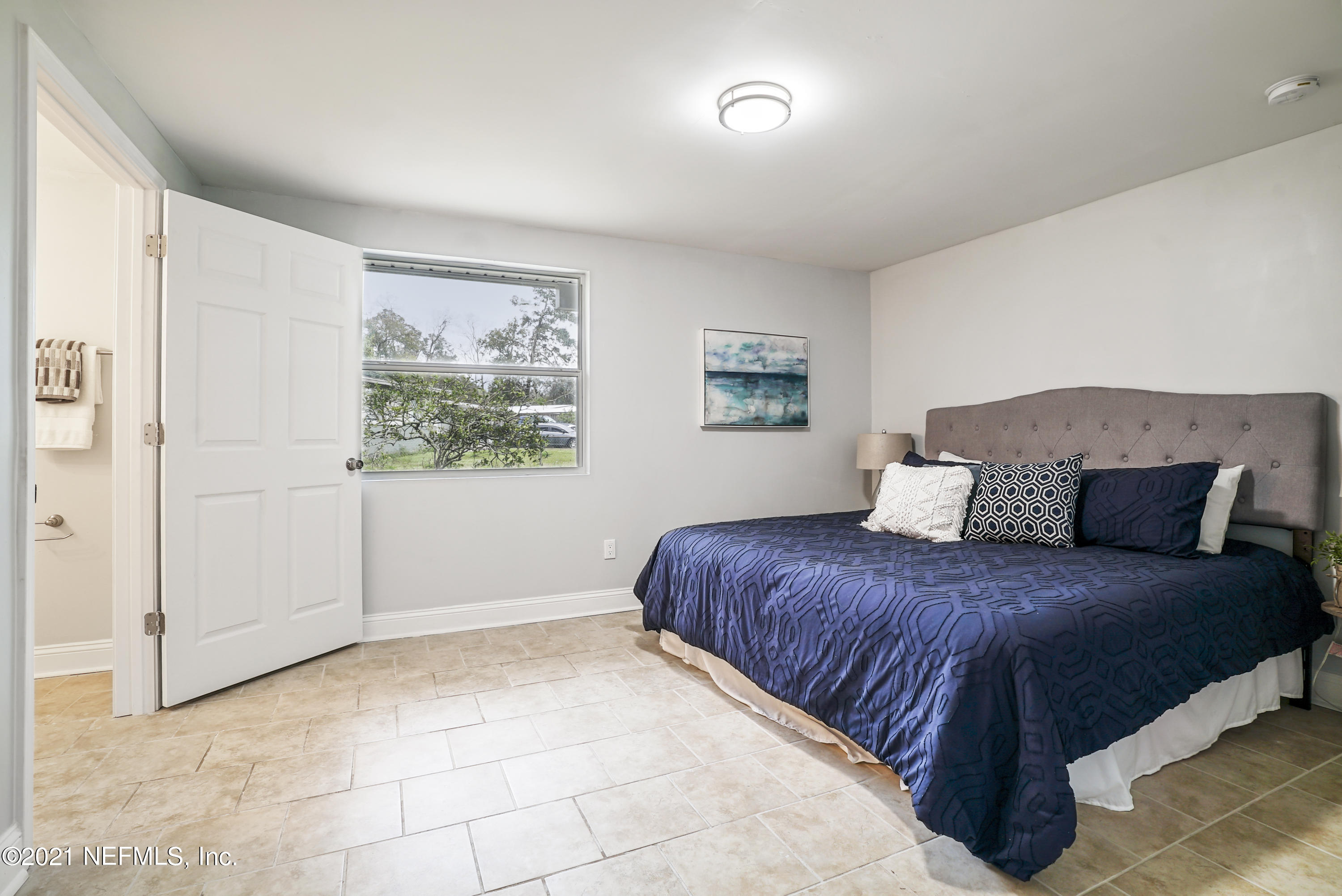 4175 Spring Glen Road Jacksonville, FL 32207 - Photo 10 of 25 a bedroom with a large bed and a window