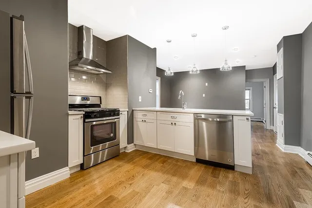 a kitchen with stainless steel appliances a refrigerator sink and stove