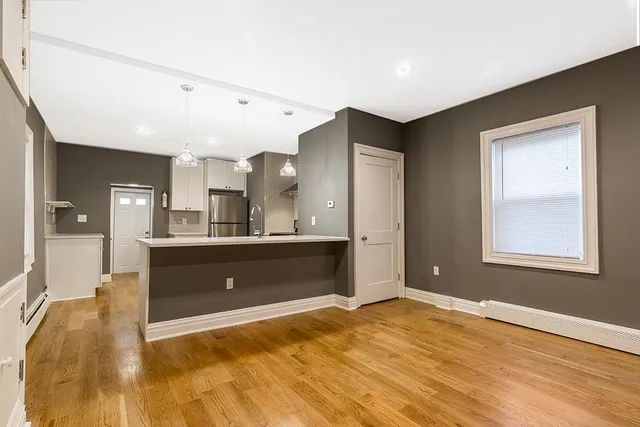 a view of a kitchen cabinets and a wooden floor