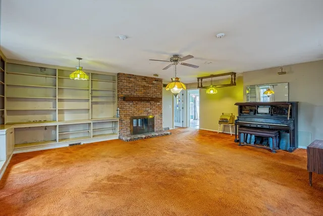 a view of a livingroom with furniture and a fireplace