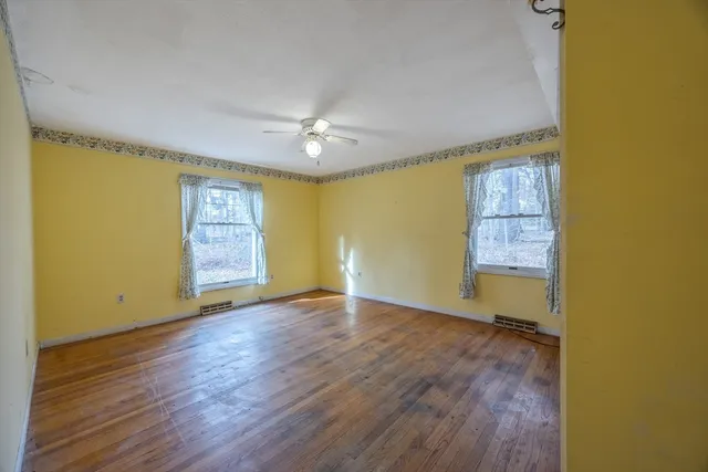 wooden floor in an empty room with a window
