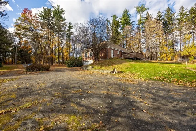 a yellow house with trees in front of it