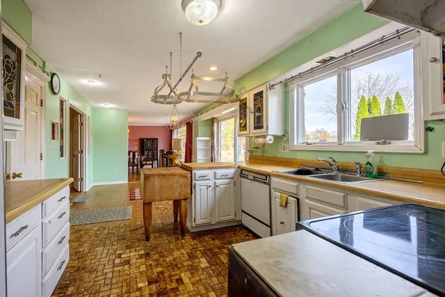 a large kitchen with a table and chairs