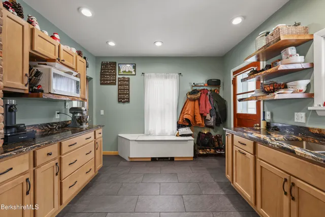 a kitchen with a sink and a stove top oven