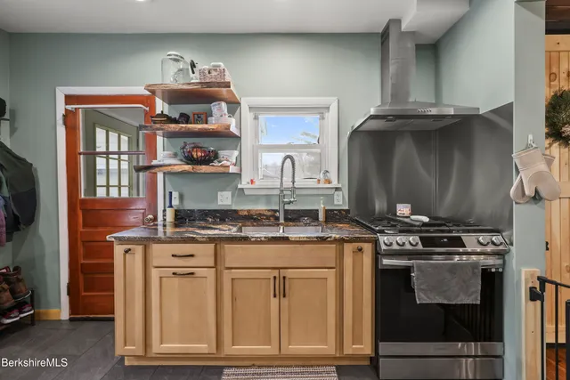 a kitchen with stainless steel appliances granite countertop a stove and a cabinets