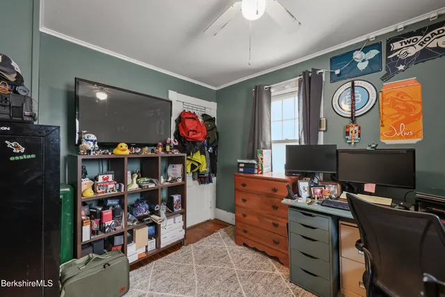 a room with a workspace and a window