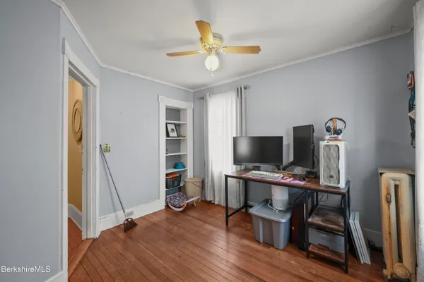 a view of a workspace with furniture and a window