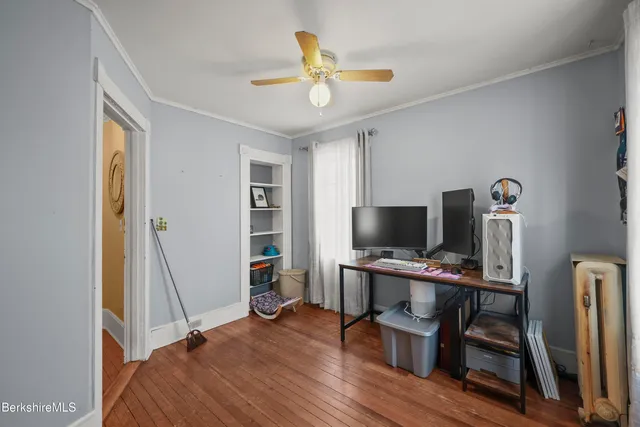 a view of a workspace with furniture and a window
