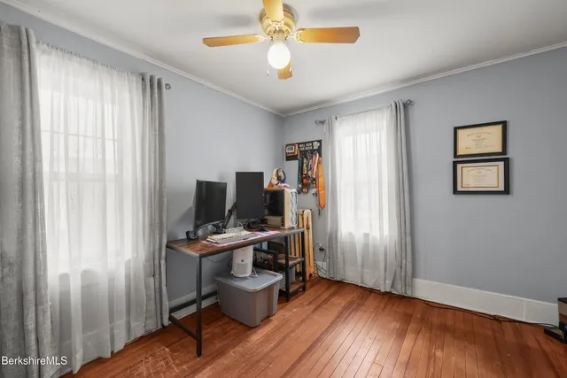 a view of a workspace with furniture and a window