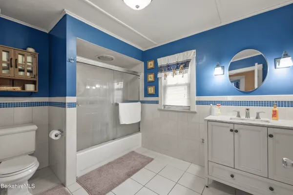 a bathroom with a toilet a sink and mirror