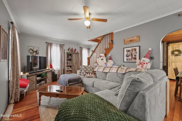 a living room with furniture a rug and a flat screen tv
