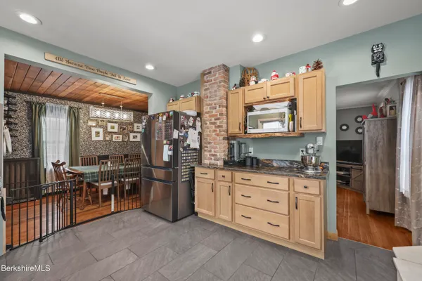 a kitchen with stainless steel appliances granite countertop a refrigerator and a stove top oven