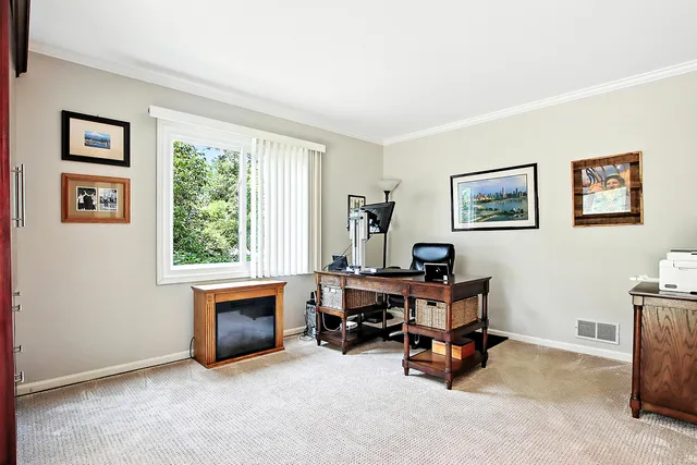 a view of a workspace with lounge chair and a window