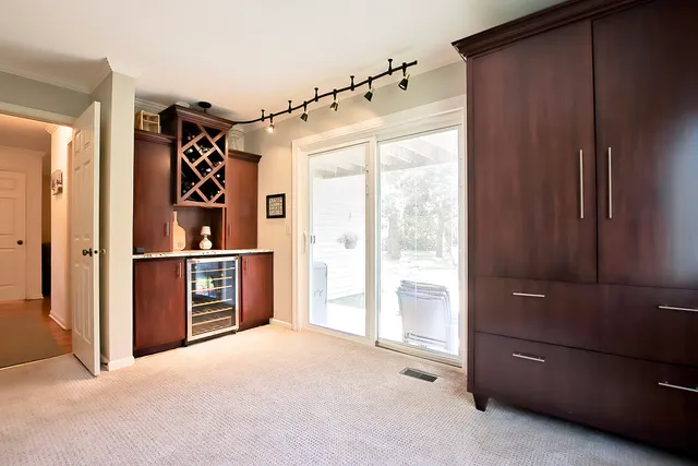 a view of a hallway with closet and cabinet