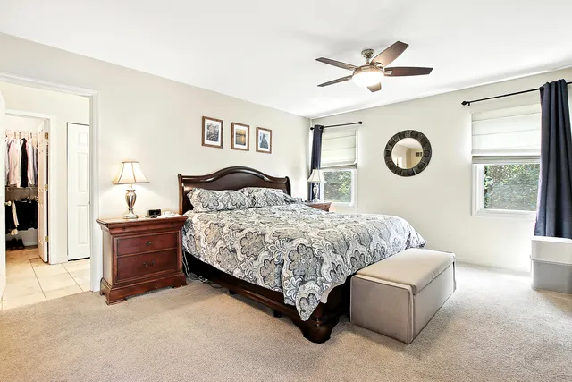 a bedroom with a bed and a wall painting