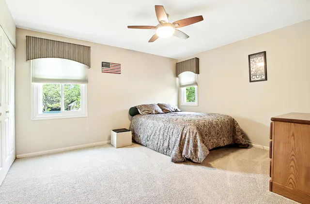 a bedroom with a large bed and a window