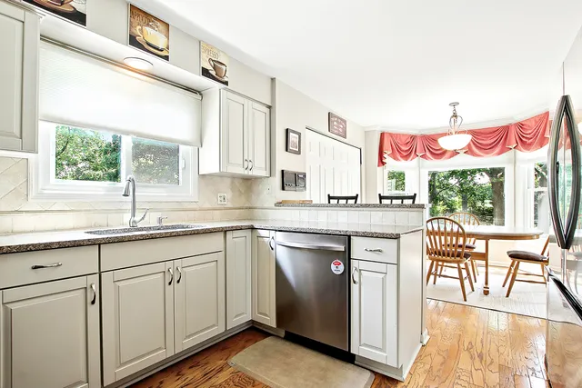 a kitchen with a sink cabinets and wooden floor