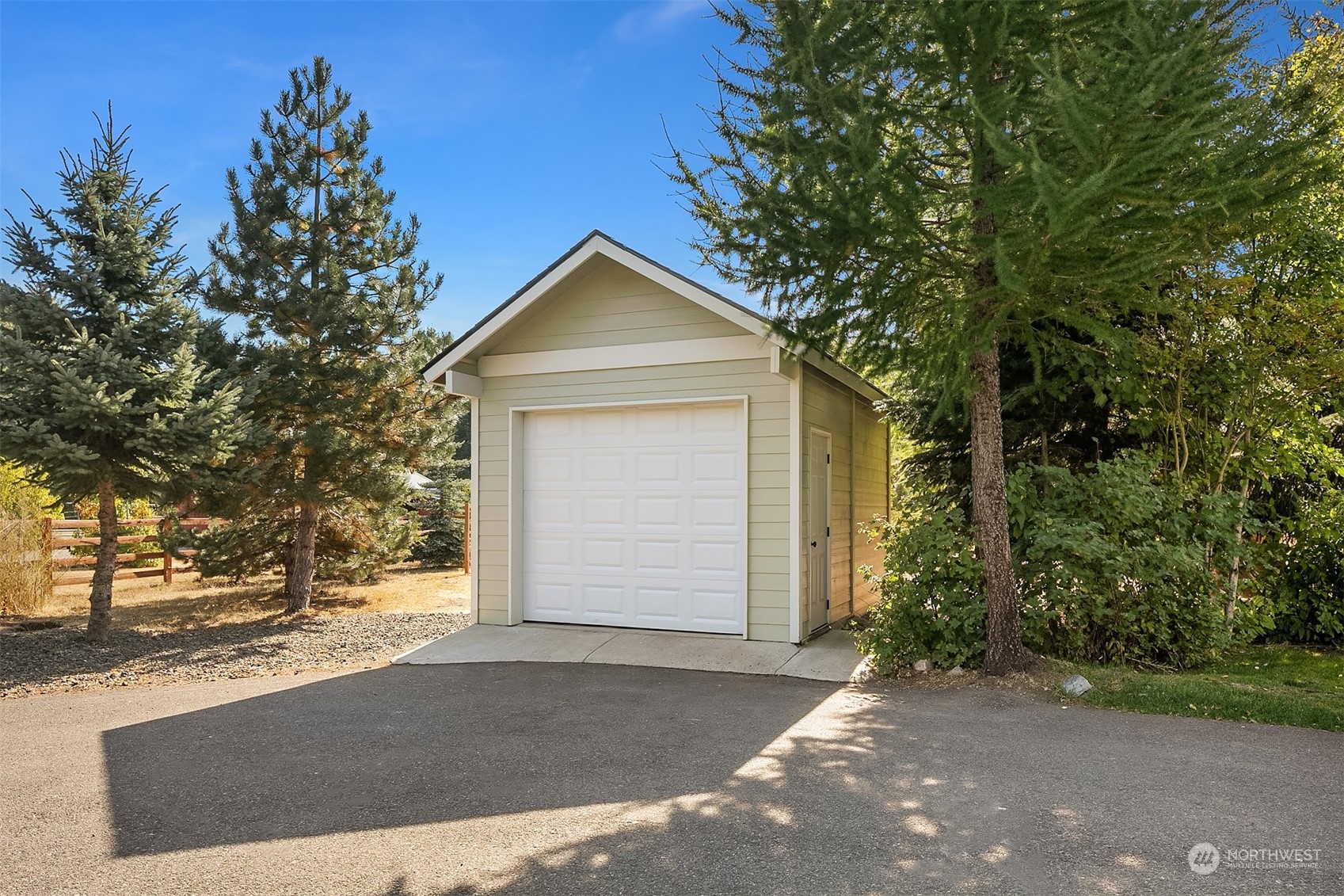 136 Old Cedars Road Cle Elum, WA 98922 - Photo 30 of 38 a front view of a house with a yard and garage