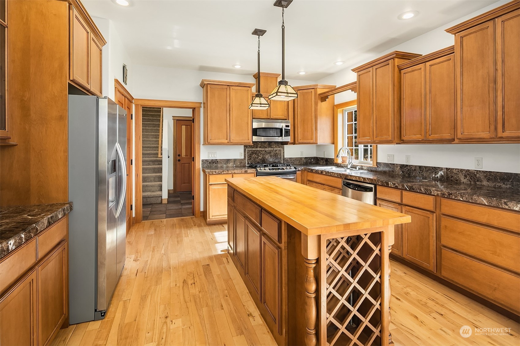136 Old Cedars Road Cle Elum, WA 98922 - Photo 8 of 38 a kitchen with stainless steel appliances granite countertop a sink a stove and a refrigerator