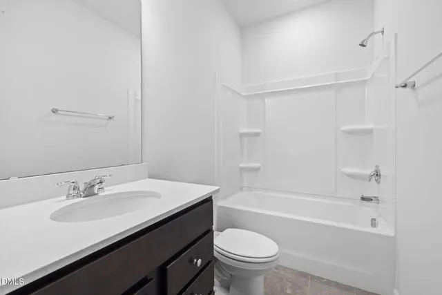 a bathroom with a granite countertop sink a toilet a bathtub and shower