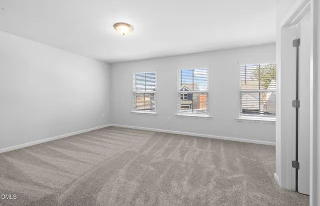 a view of a hallway with wooden floor and windows