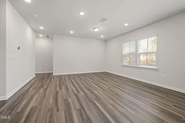 a living room with furniture a flat screen tv and a large window