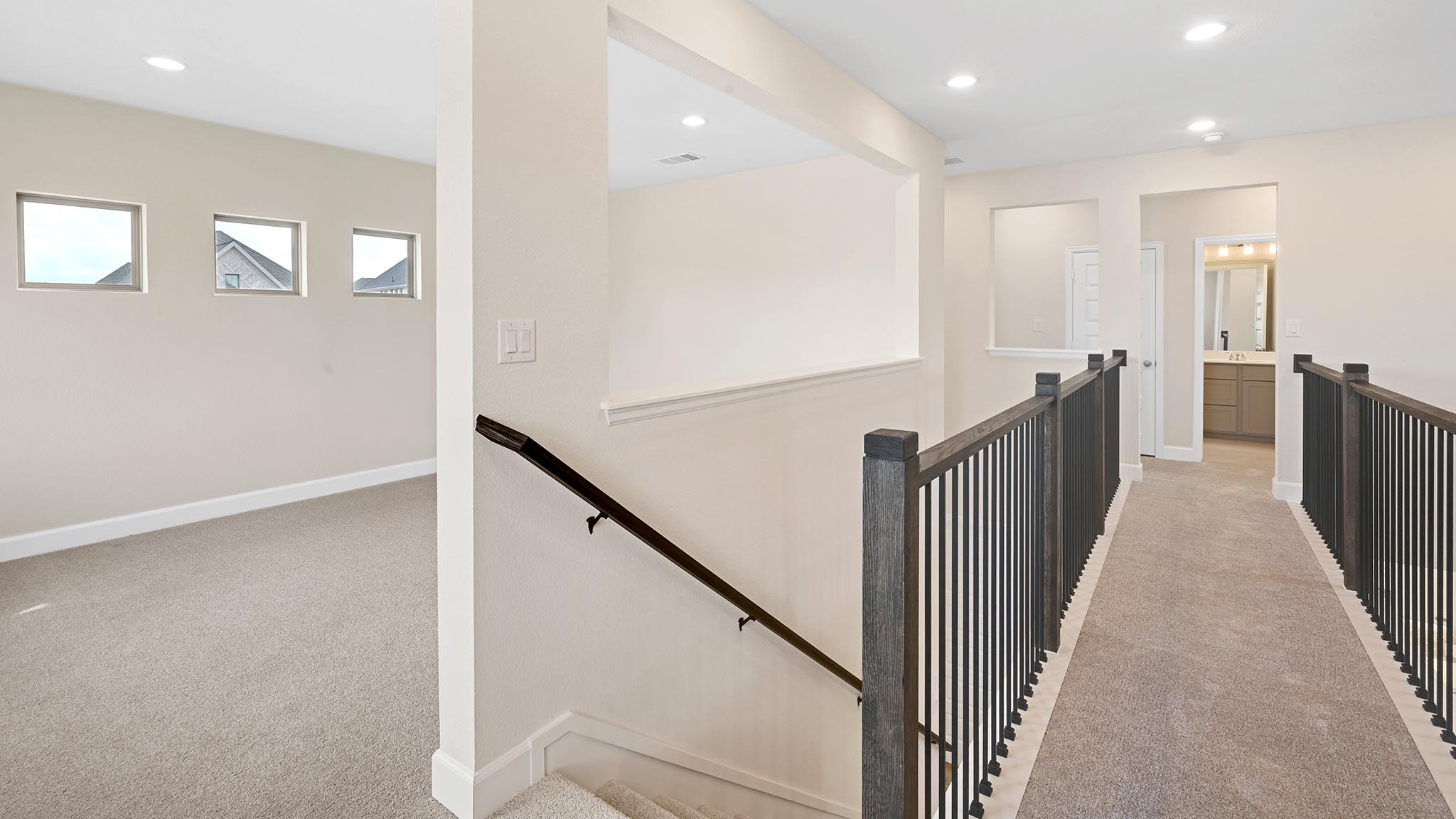 338 Prickly Poppy Loop Kyle, TX 78640 - Photo 21 of 40 Hall featuring light colored carpet, an upstairs landing, and recessed lighting