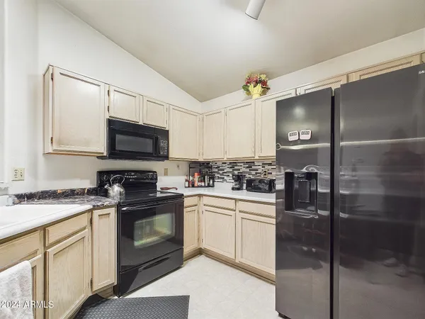 a kitchen with a sink stove and white cabinets