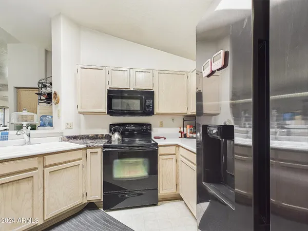 a kitchen with a sink stove and refrigerator
