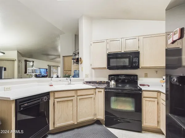 a kitchen with a sink stove and microwave