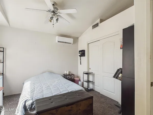 a bedroom with a bed and a chandelier